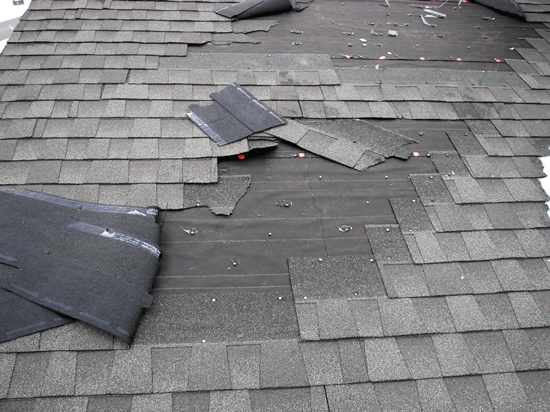 Damaged roof shingles need repair.