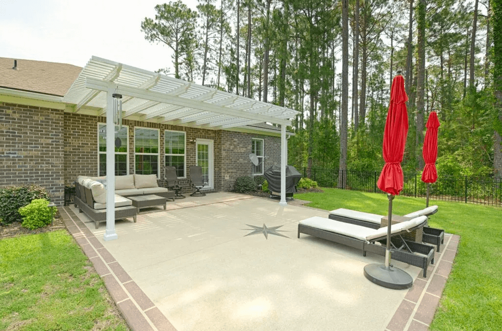 Patio with a pergola and red umbrellas.