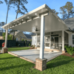 White covered patio with brick columns.