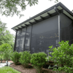 Screened-in porch with a view of the backyard.