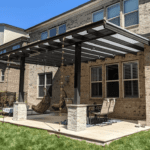 Brick house with pergola and patio furniture.